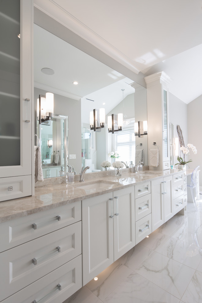 Inspiration for a large transitional master bathroom in Vancouver with recessed-panel cabinets, marble benchtops, white cabinets, a freestanding tub, a corner shower, gray tile, ceramic tile, grey walls, marble floors, an undermount sink, white floor and a hinged shower door.