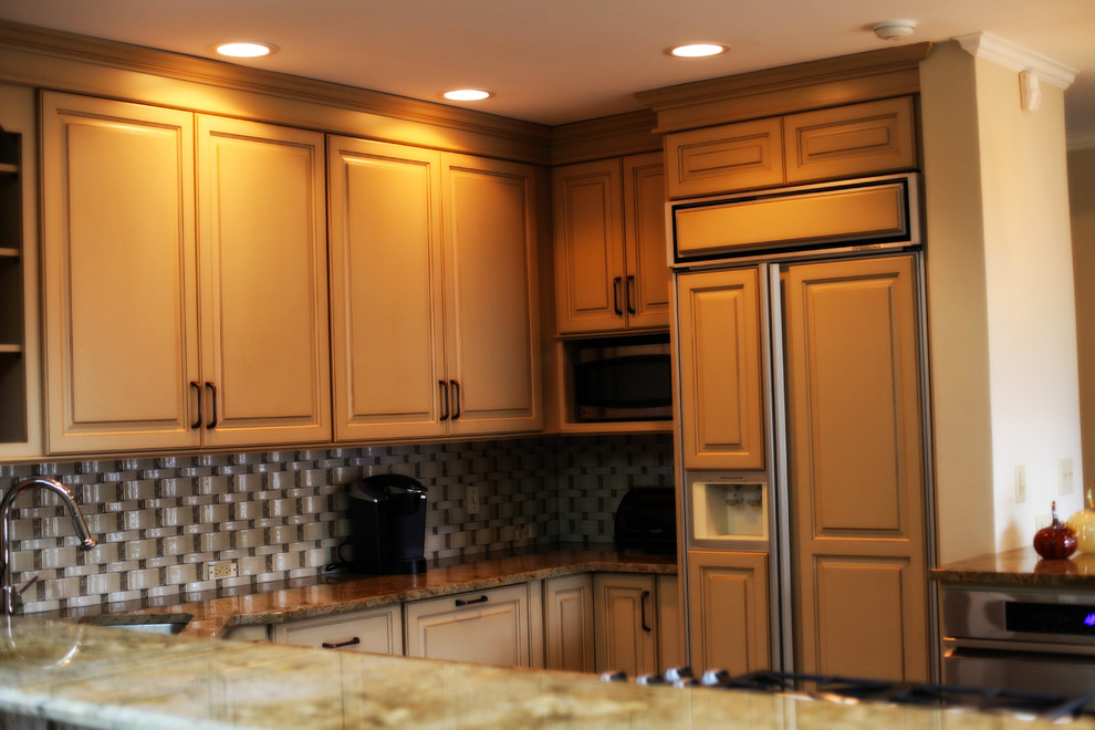 Inspiration for a small transitional dark wood floor kitchen remodel with an undermount sink, raised-panel cabinets, white cabinets, granite countertops, multicolored backsplash, ceramic backsplash and paneled appliances