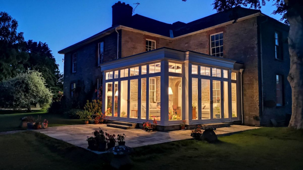 This is an example of a mid-sized traditional sunroom in Other.