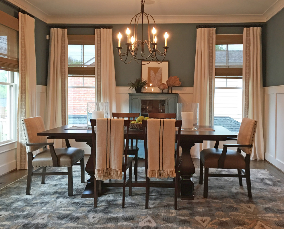 Photo of a mid-sized transitional separate dining room in DC Metro with medium hardwood floors, no fireplace, green walls, brown floor and decorative wall panelling.