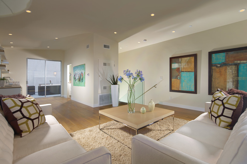 Photo of a small contemporary formal open concept living room in Orange County with beige walls, medium hardwood floors, no fireplace and no tv.