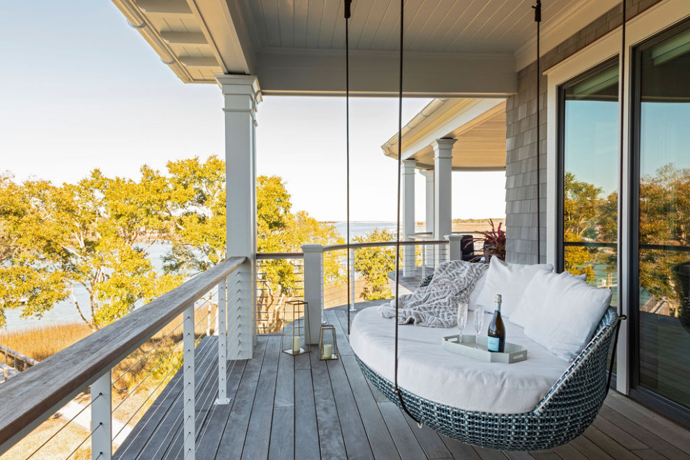 Balcony - large coastal cable railing balcony idea in Charleston with a roof extension