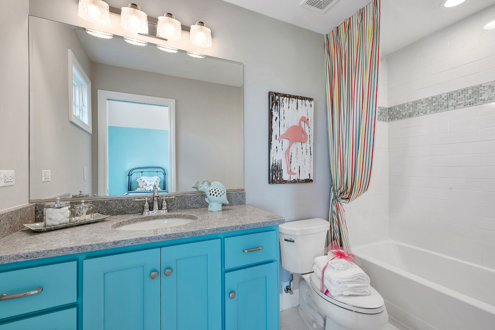 This is an example of a mid-sized beach style kids bathroom in Chicago with turquoise cabinets and an undermount sink.