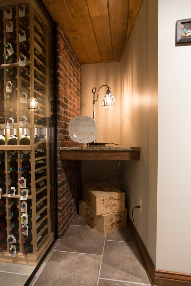 This is an example of a large country wine cellar in Chicago with porcelain floors and storage racks.