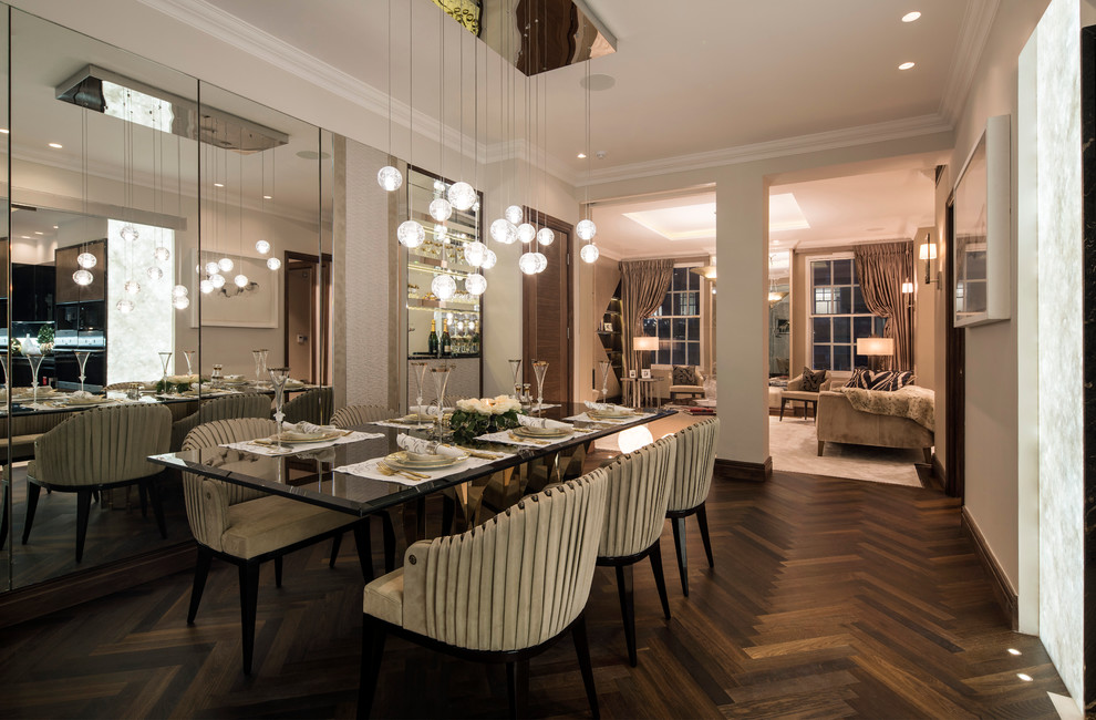Photo of a mid-sized transitional open plan dining in London with grey walls and dark hardwood floors.