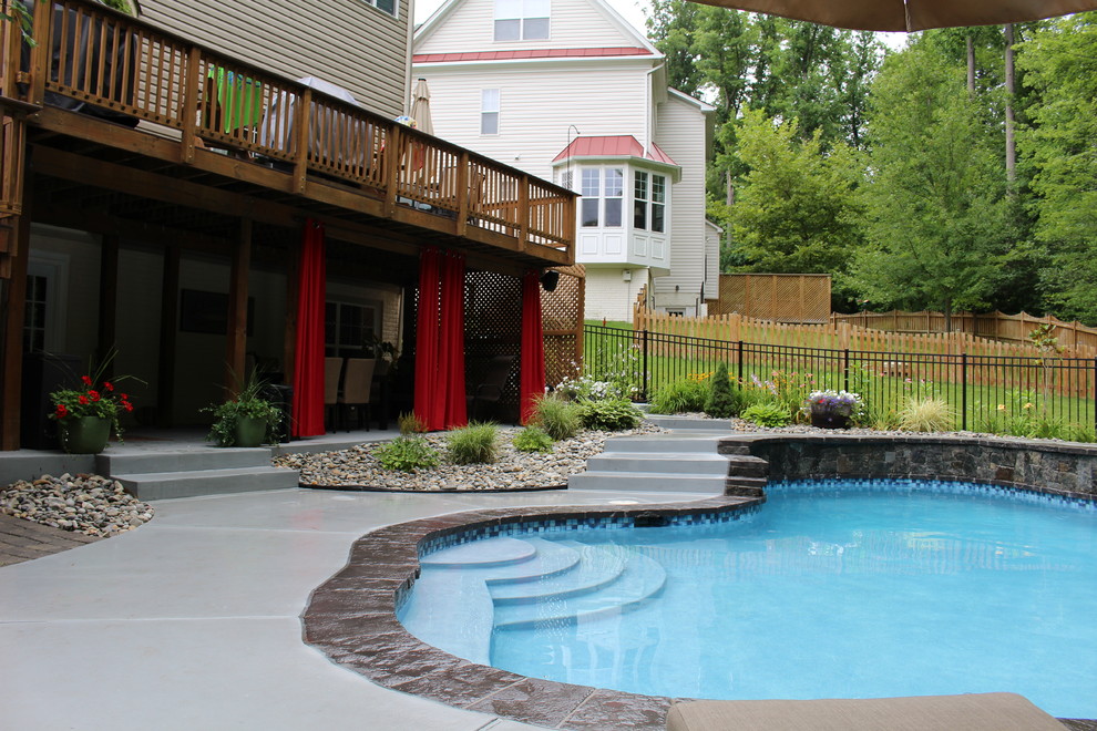 Photo of a small country backyard custom-shaped natural pool in DC Metro with decking.