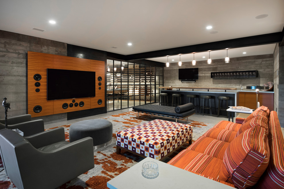 This is an example of a country home theatre in Minneapolis with a wall-mounted tv, grey floor and concrete floors.