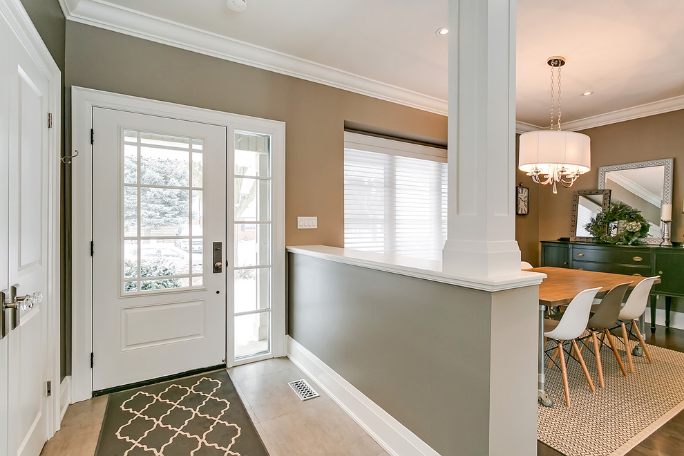 Front door - mid-sized transitional porcelain tile and beige floor front door idea in Toronto with brown walls and a white front door