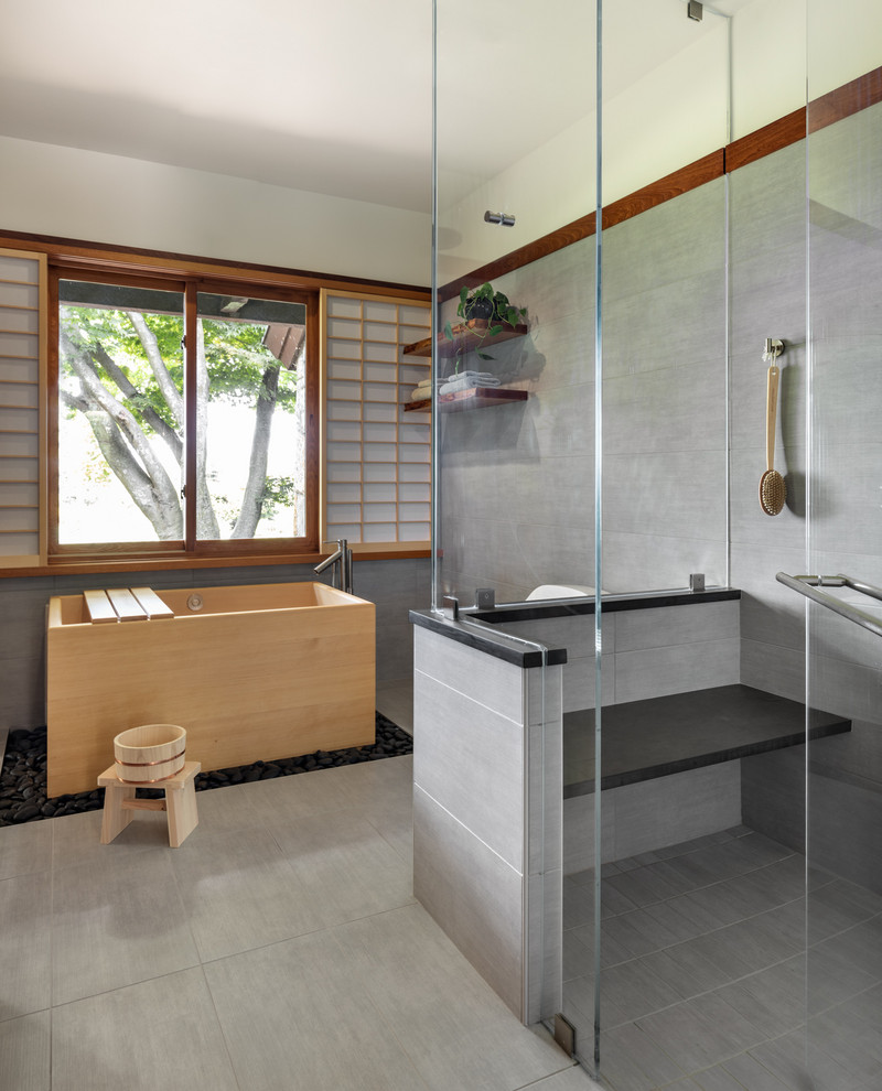 Design ideas for an asian master bathroom in New York with a japanese tub, an open shower, white walls, grey floor and an open shower.
