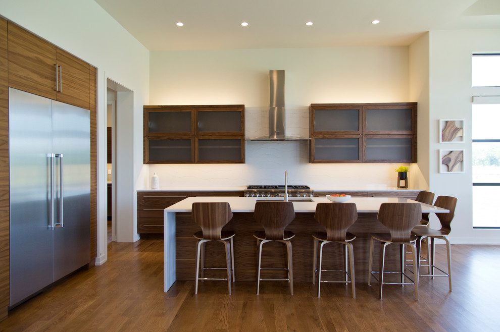 Inspiration for a large contemporary l-shaped eat-in kitchen in Kansas City with glass-front cabinets, medium wood cabinets and with island.