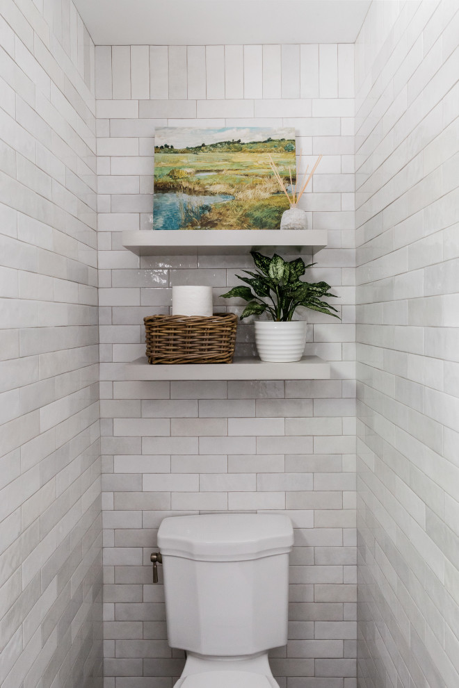 Photo of a 3/4 bathroom in Boston with flat-panel cabinets, blue cabinets, an alcove shower, a two-piece toilet, beige tile, ceramic tile, beige walls, limestone floors, an undermount sink, engineered quartz benchtops, beige floor, a hinged shower door, beige benchtops, a single vanity and a built-in vanity.