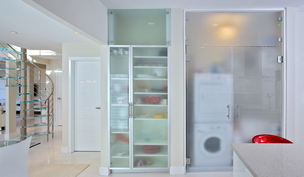 Inspiration for a contemporary laundry cupboard in Baltimore with a stacked washer and dryer.