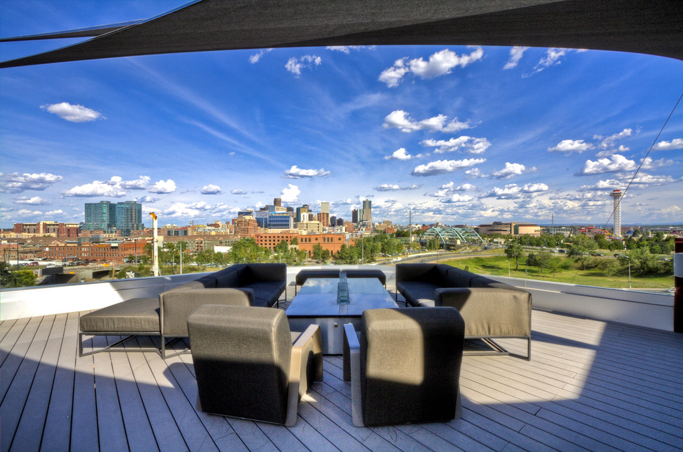 Inspiration for a large contemporary rooftop deck in Denver with an awning.