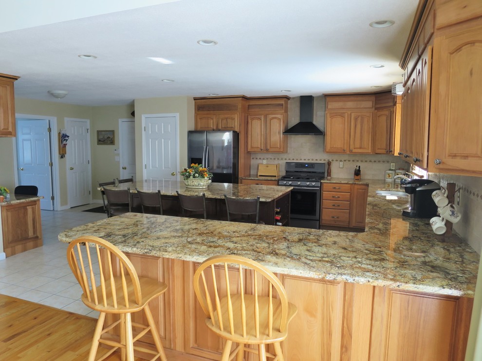 Eat-in kitchen - mid-sized transitional u-shaped ceramic tile and white floor eat-in kitchen idea in Bridgeport with a double-bowl sink, raised-panel cabinets, light wood cabinets, granite countertops, white backsplash, subway tile backsplash, stainless steel appliances and an island