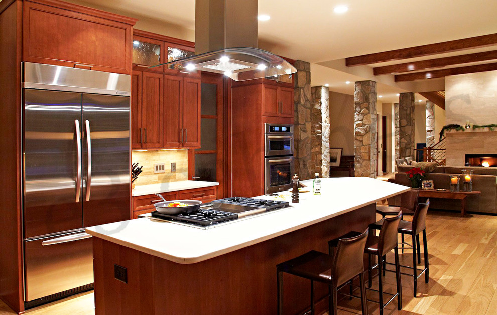 Eat-in kitchen - transitional l-shaped eat-in kitchen idea in Charlotte with an undermount sink, flat-panel cabinets, medium tone wood cabinets, quartz countertops, beige backsplash, stone tile backsplash and stainless steel appliances