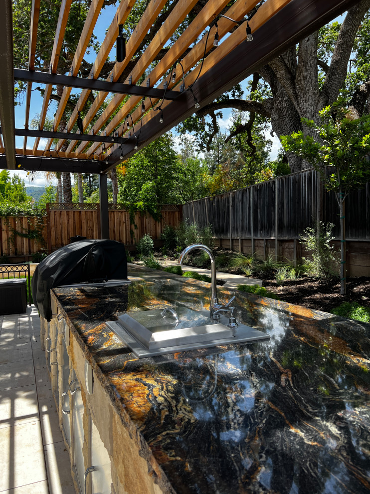 Photo of a large back patio in San Francisco with an outdoor kitchen and a pergola.