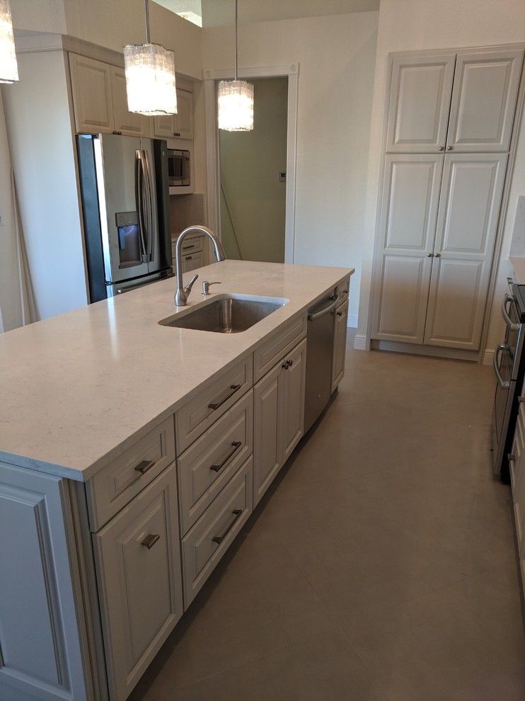 Mid-sized transitional u-shaped porcelain tile and gray floor eat-in kitchen photo in Miami with an undermount sink, shaker cabinets, beige cabinets, quartz countertops, white backsplash, stone slab backsplash, stainless steel appliances, an island and white countertops