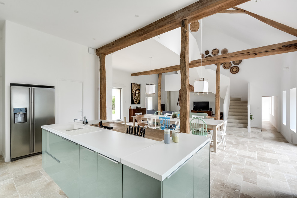 Photo of an expansive scandinavian l-shaped open plan kitchen in Other with a double-bowl sink, beaded inset cabinets, green cabinets, laminate benchtops, white splashback, porcelain splashback, stainless steel appliances, marble floors, with island and beige floor.
