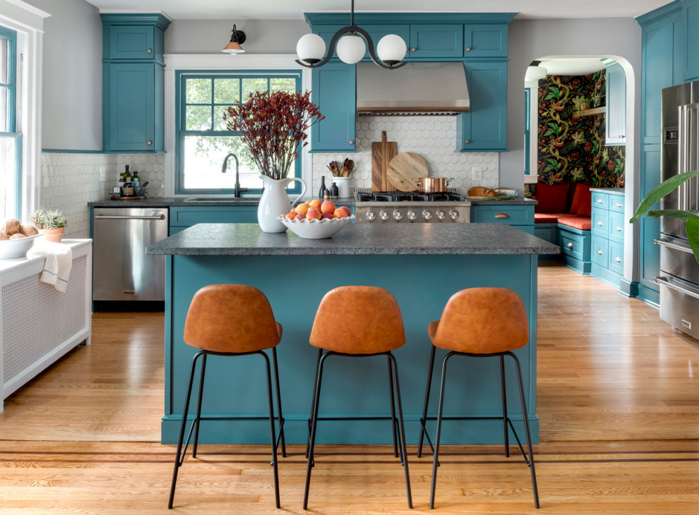 Exempel på ett mellanstort eklektiskt grå linjärt grått kök och matrum, med en undermonterad diskho, skåp i shakerstil, blå skåp, granitbänkskiva, vitt stänkskydd, stänkskydd i keramik, rostfria vitvaror, ljust trägolv, en köksö och orange golv