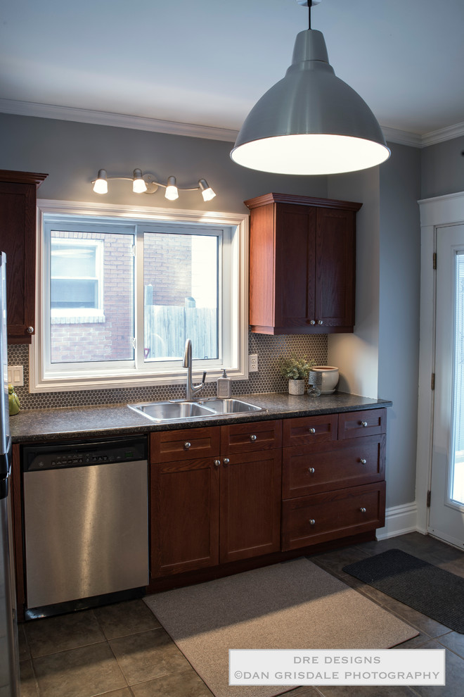 Inspiration for a mid-sized transitional ceramic tile home design remodel in Toronto with a double-bowl sink, shaker cabinets, medium tone wood cabinets, laminate countertops, gray backsplash, mosaic tile backsplash and stainless steel appliances