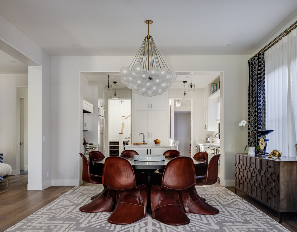 This is an example of a transitional dining room in San Francisco with white walls and medium hardwood floors.