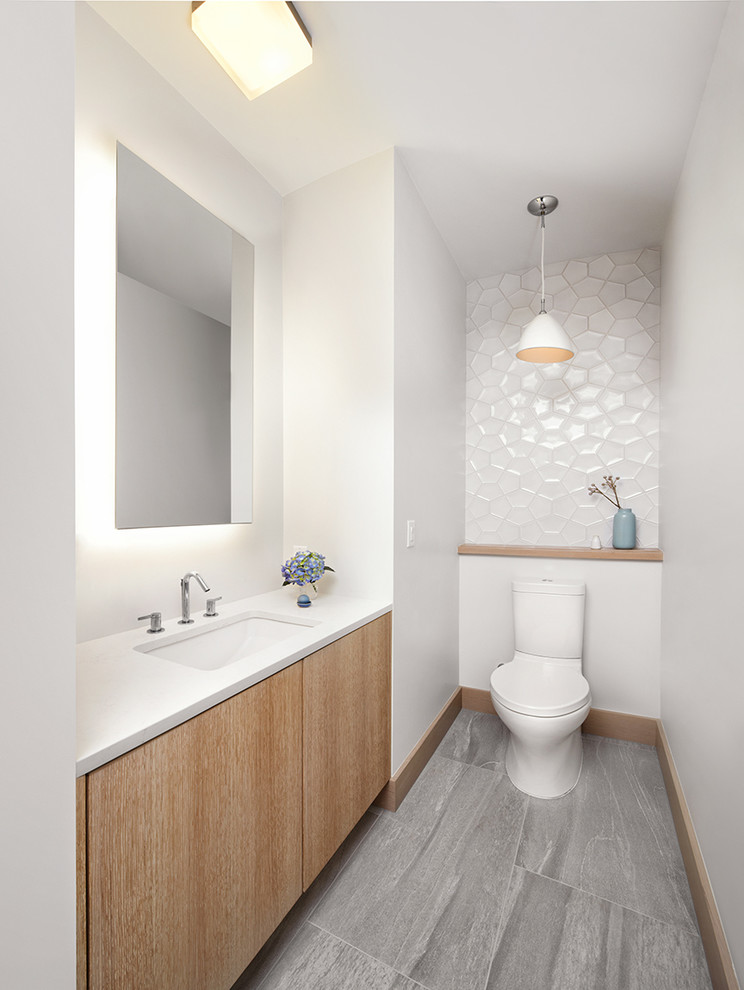 Inspiration for a large modern 3/4 bathroom in San Francisco with an undermount sink, flat-panel cabinets, light wood cabinets, engineered quartz benchtops, a two-piece toilet, white tile, white walls and porcelain floors.