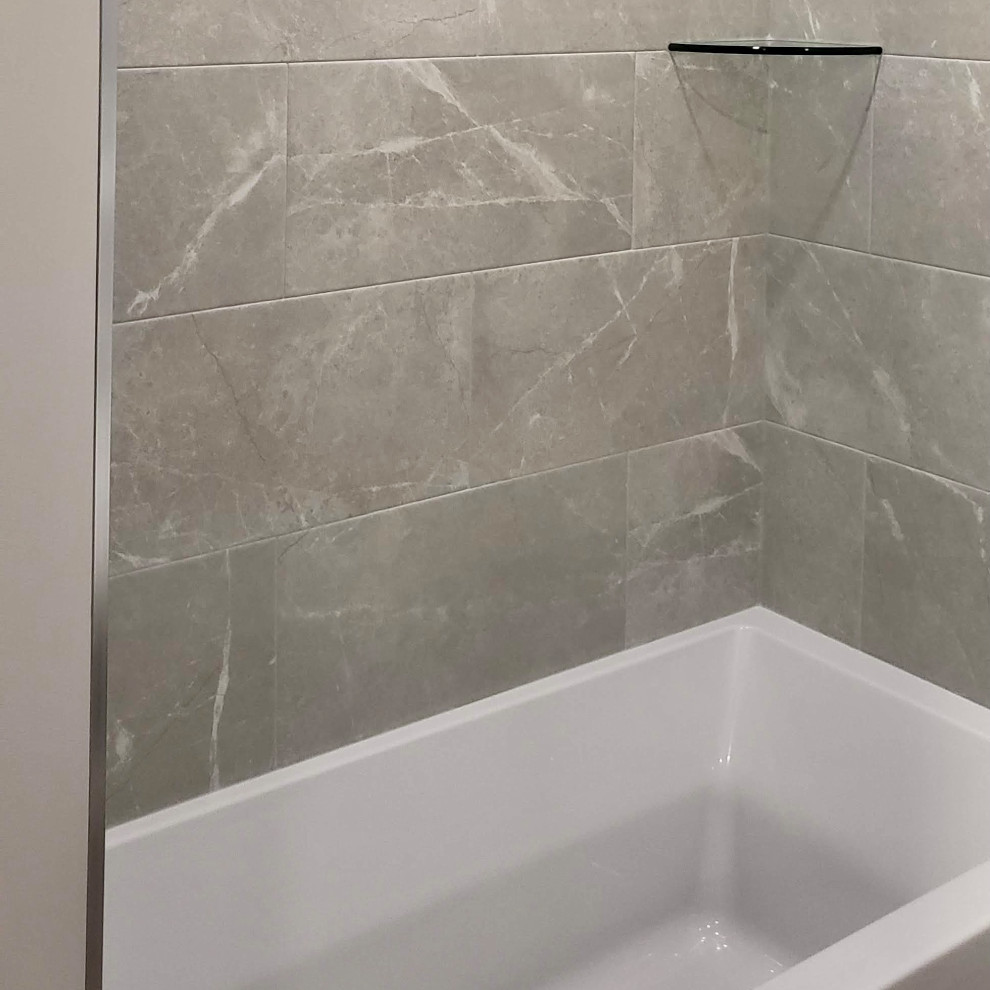 Alcove bathtub - small transitional 3/4 porcelain tile, gray floor and single-sink alcove bathtub idea with shaker cabinets, white cabinets, a one-piece toilet, beige walls, an undermount sink, quartzite countertops, multicolored countertops and a freestanding vanity