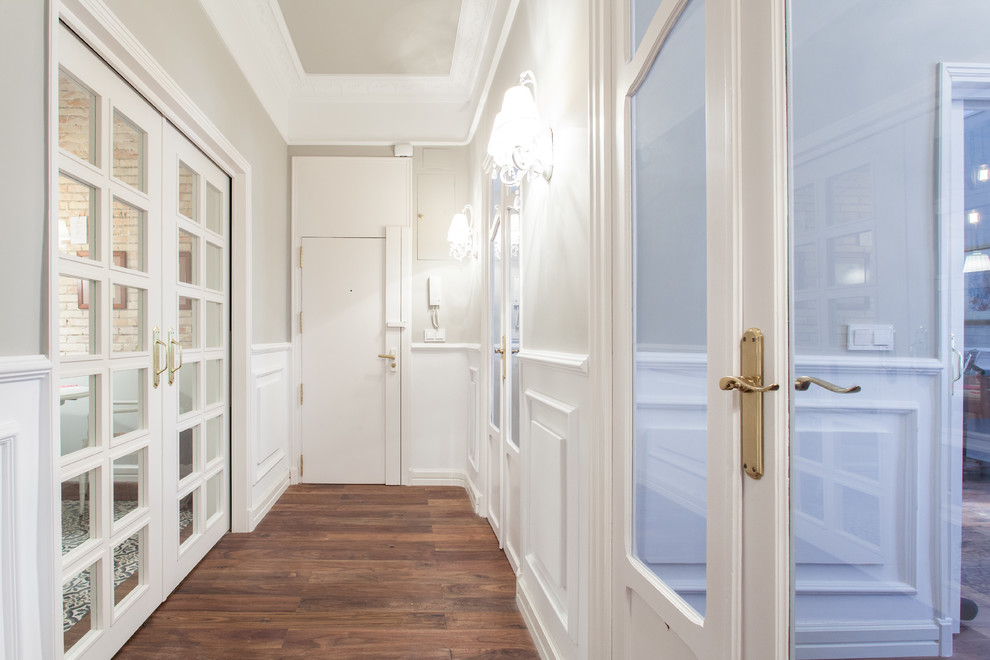 This is an example of a mid-sized transitional hallway in Alicante-Costa Blanca with white walls and medium hardwood floors.