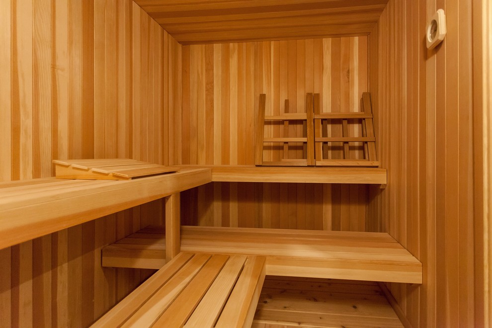 Photo of a contemporary bathroom in DC Metro with light wood cabinets, with a sauna and beige floor.