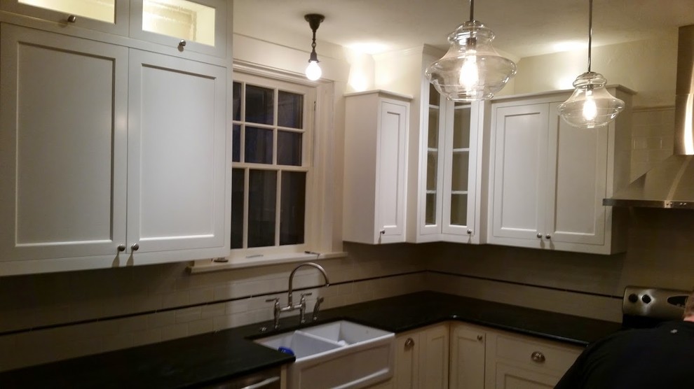 Small transitional u-shaped separate kitchen in Boise with a farmhouse sink, shaker cabinets, white cabinets, white splashback, subway tile splashback, stainless steel appliances, a peninsula and soapstone benchtops.
