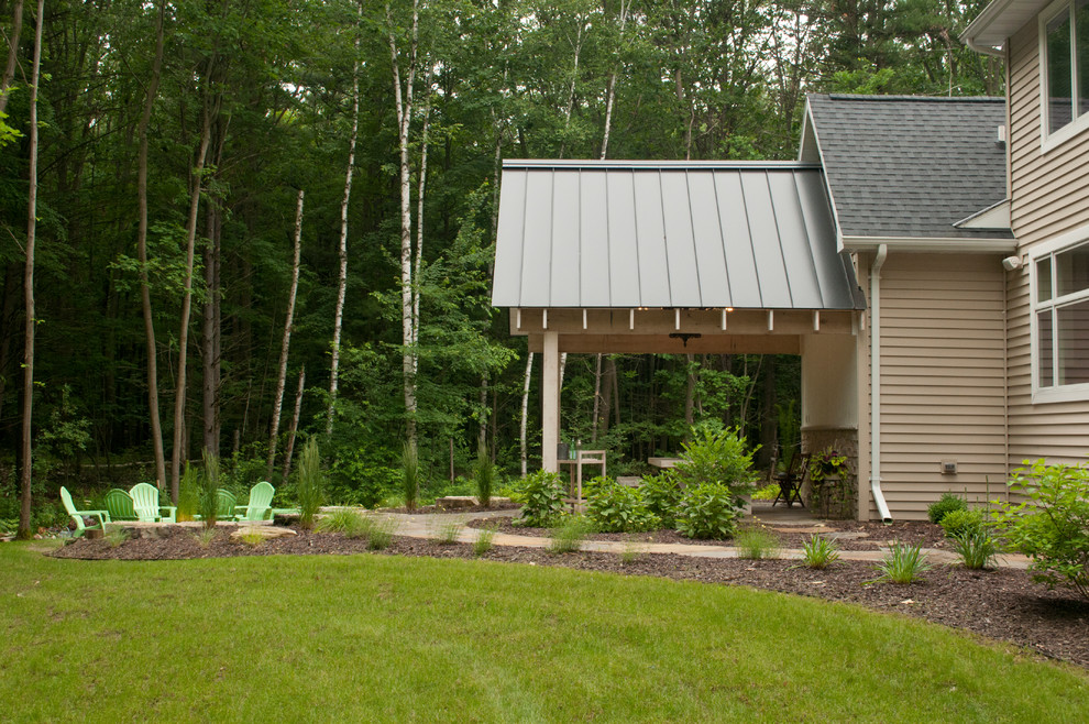 Mid-sized transitional backyard concrete patio photo with a fire pit and a roof extension