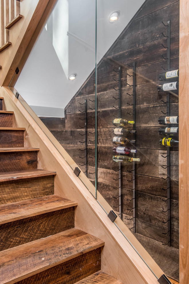 Inspiration for a mid-sized country wine cellar in Other with dark hardwood floors, diamond bins and brown floor.