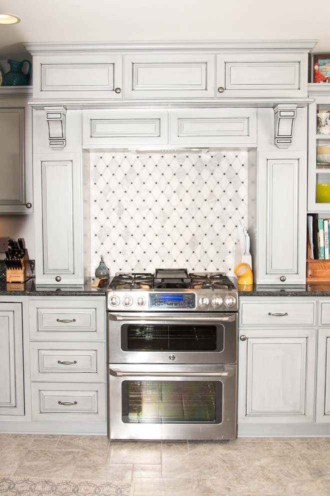 Inspiration for a large transitional u-shaped porcelain tile and beige floor eat-in kitchen remodel in Milwaukee with an undermount sink, raised-panel cabinets, gray cabinets, granite countertops, white backsplash, marble backsplash, stainless steel appliances and no island