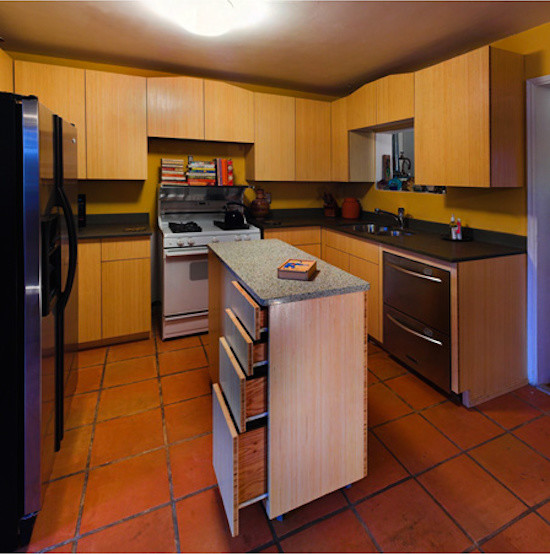 Enclosed kitchen - small transitional l-shaped ceramic tile enclosed kitchen idea in Phoenix with a drop-in sink, flat-panel cabinets, light wood cabinets, granite countertops, stainless steel appliances and an island