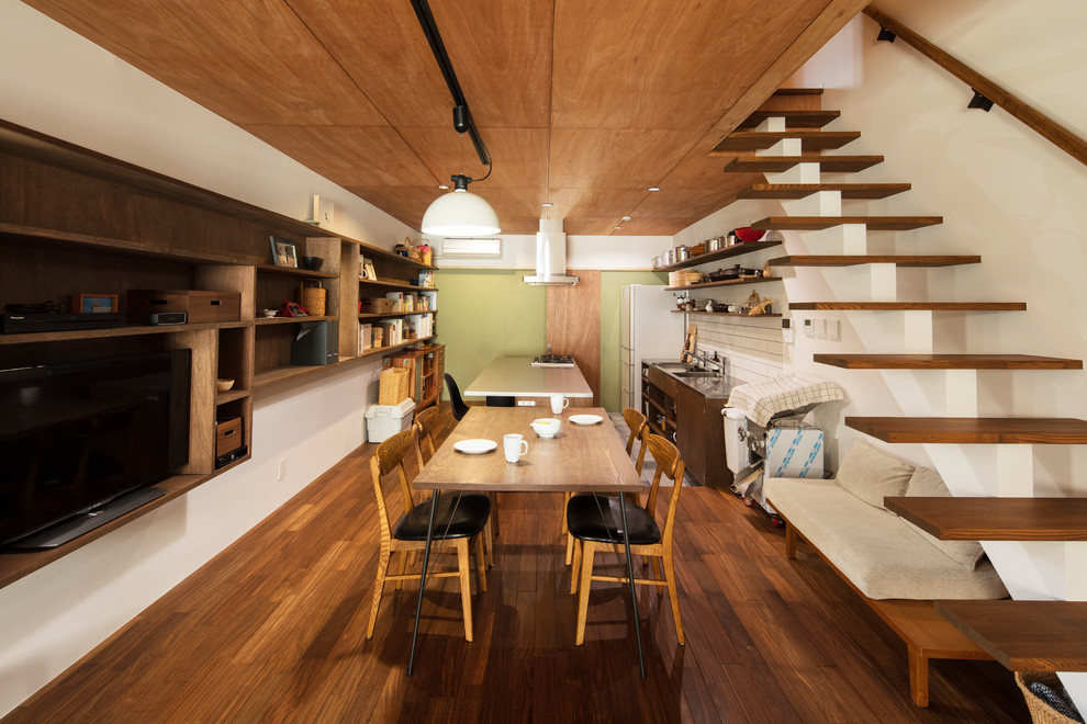 Photo of a contemporary open plan dining in Osaka with white walls, brown floor and dark hardwood floors.