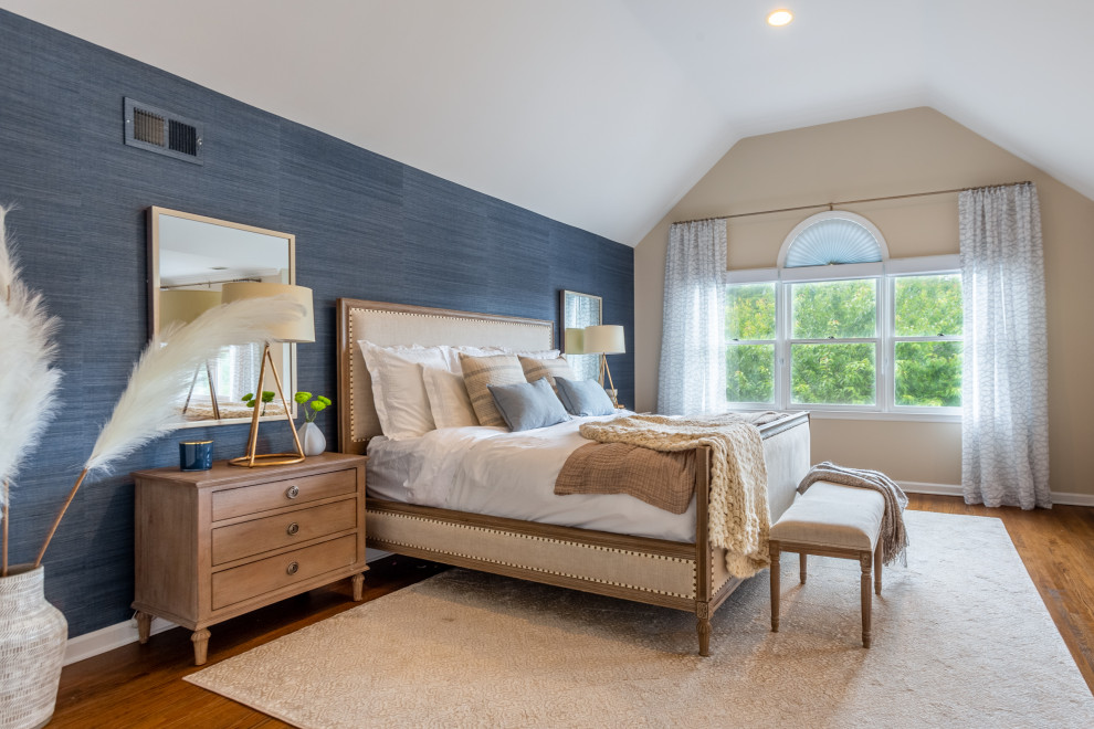This is an example of a large modern master bedroom in New York with blue walls, light hardwood floors, no fireplace, beige floor, vaulted and wallpaper.