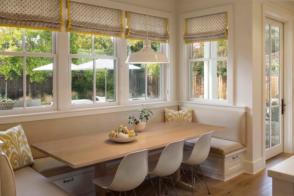 Country kitchen/dining combo in San Francisco with white walls and light hardwood floors.