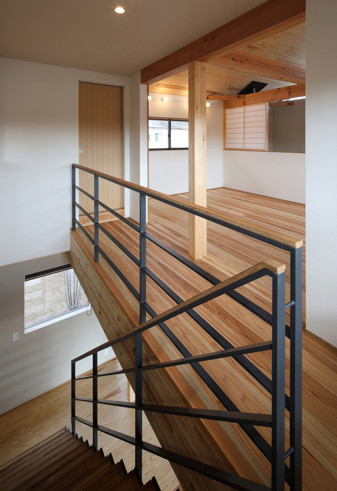 Mid-sized asian wood straight staircase in Other with open risers and mixed railing.