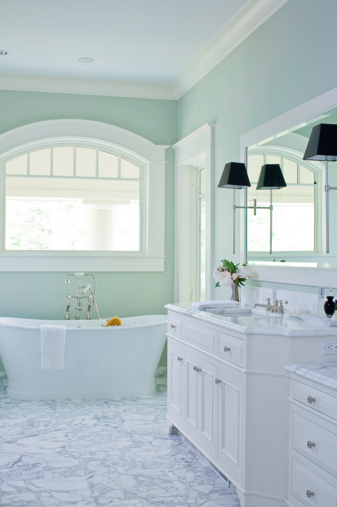 Traditional bathroom in Other with recessed-panel cabinets, white cabinets, a freestanding tub, green walls, an undermount sink, grey floor and white benchtops.