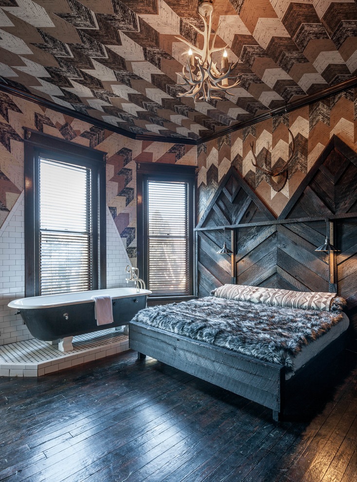 Country bedroom in Nashville with multi-coloured walls and dark hardwood floors.