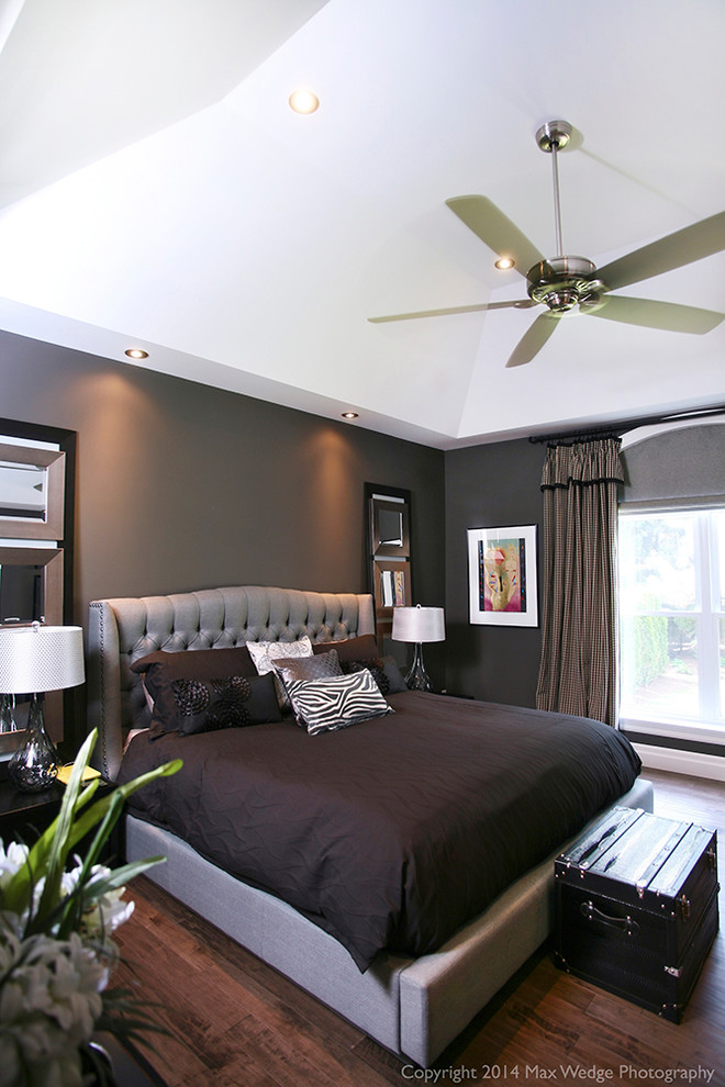 This is an example of a large contemporary master bedroom in Toronto with grey walls, dark hardwood floors and no fireplace.