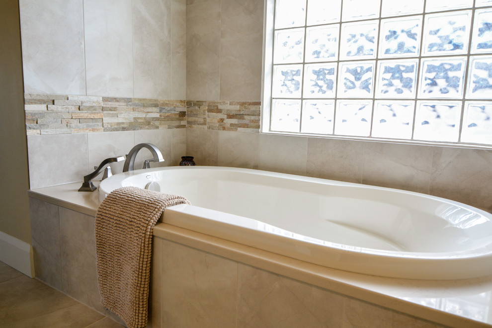 Inspiration for a mid-sized transitional master bathroom in Calgary with recessed-panel cabinets, medium wood cabinets, an alcove shower, a two-piece toilet, beige walls, ceramic floors, an undermount sink and soapstone benchtops.