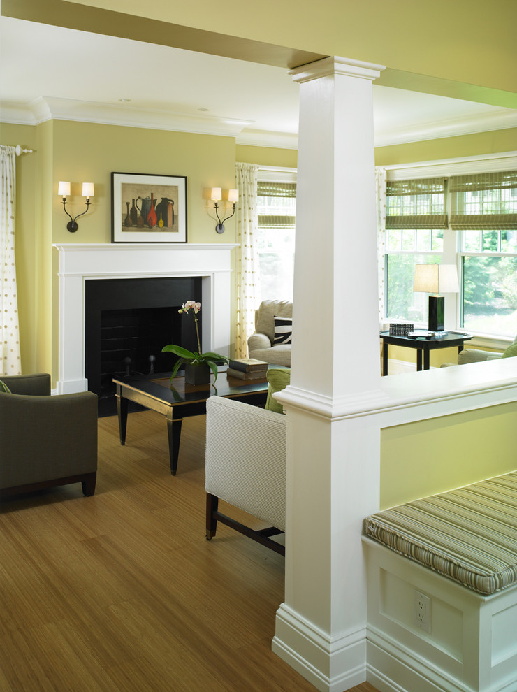 Traditional living room in Boston with yellow walls, a standard fireplace and no tv.