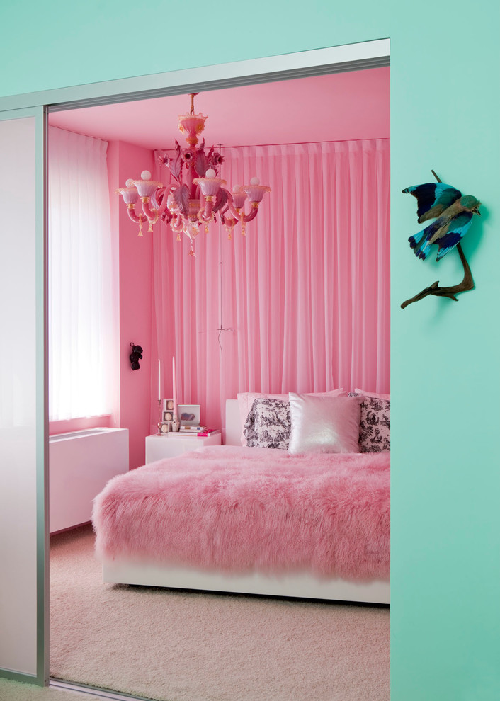 Photo of an eclectic bedroom in New York with pink walls, carpet and beige floor.