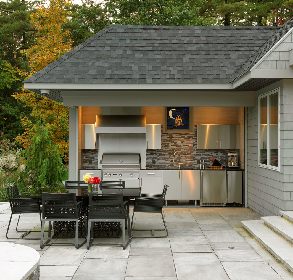 This is an example of a transitional backyard patio in Burlington with an outdoor kitchen and a roof extension.