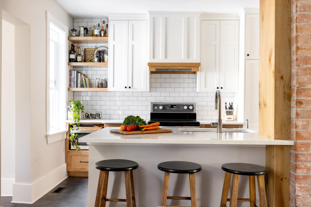 Design ideas for a small rural galley kitchen/diner in Calgary with a submerged sink, shaker cabinets, white cabinets, quartz worktops, white splashback, metro tiled splashback, integrated appliances, terracotta flooring, an island, grey floors and white worktops.
