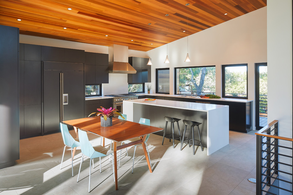 This is an example of a midcentury l-shaped eat-in kitchen in Austin with a drop-in sink, quartz benchtops, stainless steel appliances, ceramic floors, with island, grey floor, white benchtop, flat-panel cabinets and grey cabinets.