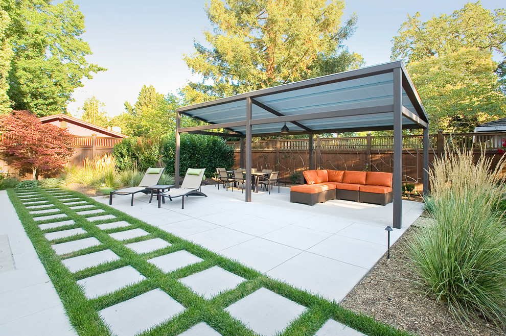 This is an example of a mid-sized contemporary backyard patio in San Francisco with concrete pavers.