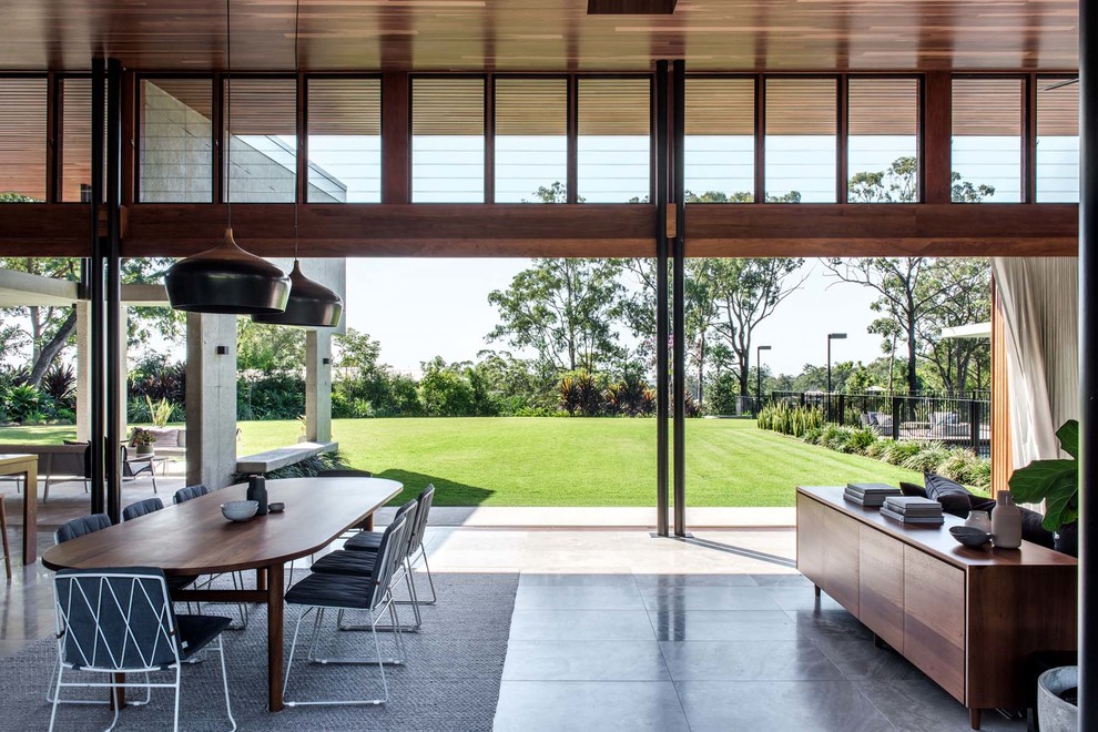 Modern open concept living room in Brisbane with grey floor.