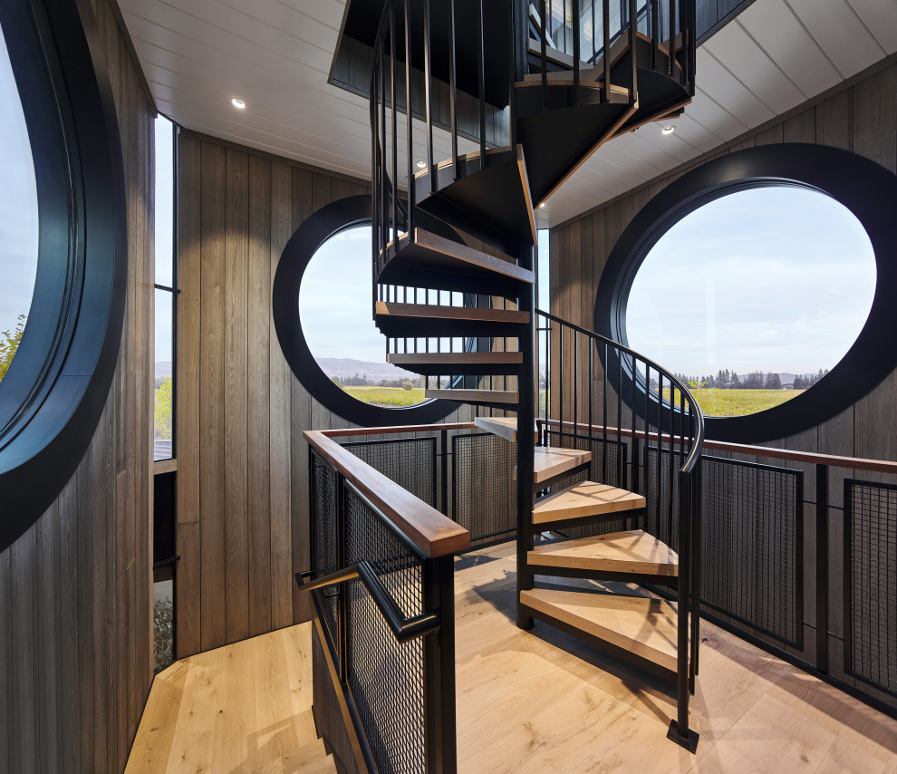 Design ideas for a large contemporary wood spiral staircase in San Francisco with open risers, metal railing and wood walls.